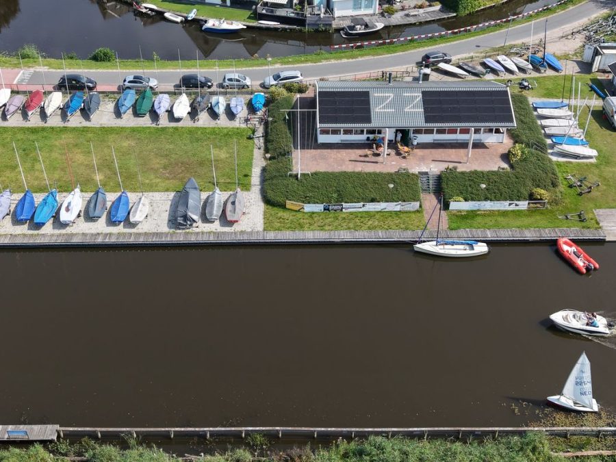 Luchtfoto van het clubhuis, gestalde boten en het water